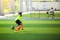Selective focus to goalkeeper is jumping to catching the soccer ball. Blurry ball after going out from hands of goalkeeper on Royalty Free Stock Photo