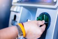 Selective focus to hand inserting a credit card in the ATM Royalty Free Stock Photo