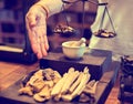 Selective focus to herb medicine mortar with doctor hand and blurry agarwood on vintage balance scale in Chinese or Thai herbal Royalty Free Stock Photo