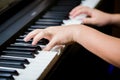 Selective focus to kid fingers and piano key to play the piano. There are musical instrument for concert or learning music