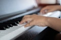 Selective focus to kid fingers and piano key to play the piano. There are musical instrument for concert or learning music Royalty Free Stock Photo