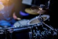 Selective focus to mini cymbals of drum set with blurry kid learning and play drum set with teacher in music room. Royalty Free Stock Photo