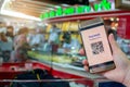 Selective focus to QR Code tag on smart phone in hand of customer with blurry gold jewelry shop to accepted generate digital pay Royalty Free Stock Photo