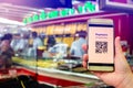 Selective focus to QR Code tag on smart phone in hand of customer with blurry gold jewelry shop to accepted generate digital pay Royalty Free Stock Photo