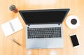 Selective focus,Top view of wooden desktop with laptop, blank mobile phone, pen, coffee cup,cactus and notebook Royalty Free Stock Photo