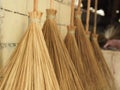 Selective focus of traditional stick brooms  placed against a brick wall Royalty Free Stock Photo