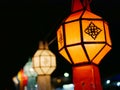 Traditional Thai Lanna hanging paper lanterns being used to decorate the street during the night