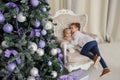 Selective focus on tree. In background are two kids brother and sister are sitting on a vintage armchair in a white room Royalty Free Stock Photo