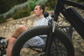 Selective focus on tubeless tire of an electric motor bike, mountain bike over blurred background of male cyclist in the