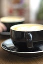 selective focus. Two cups of cappuccino with latte art on wooden background. Royalty Free Stock Photo