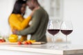 Selective Focus On Two Wine Glasses With Romantic Black Couple On Background Royalty Free Stock Photo