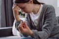 Selective focus of upset worried young woman holding wedding ring think of marriage dissolution or divorce having family problems Royalty Free Stock Photo