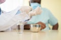 Selective focus of Vaccine bottle, African American Wear a medical mask and being covid vaccinated for the prevention of