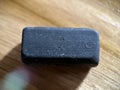 Black rubber eraser on wooden background