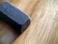 Black rubber eraser on wooden background