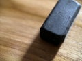 Black rubber eraser on wooden background