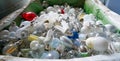 Selective focus view of large recycling bin filled with many different size and color light bulbs Royalty Free Stock Photo