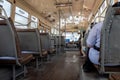 Selective focus view at metal handrail of the row of seats in old local hot public transportation bus Royalty Free Stock Photo