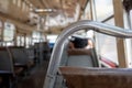 Selective focus view at metal handrail of the row of seats in old local hot public transportation bus Royalty Free Stock Photo