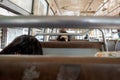 Selective focus view at metal handrail of the row of seats in old local hot public transportation bus Royalty Free Stock Photo