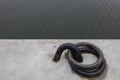 Rusty boat tie ring with blur background of dark water. Royalty Free Stock Photo