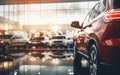 Selective focus view of a SUV in the interior of a luxury car dealership with shiny new cars inside