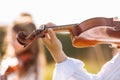 Selective focus at the violin of a young little girl playing outdoor during the summer festival. Royalty Free Stock Photo