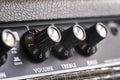 Selective focus of the volume, treble and bass control knobs of a guitar amplifier, equalization dials close up Royalty Free Stock Photo