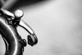 Selective focus on a water key of an aged wind instrument trumpet.