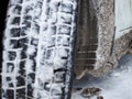 Selective focus. The wheel arch of the car is clogged with ice and snow