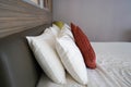Selective focus close up white fluffy pillows on double bed for sleep well