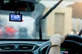 Selective focus of woman driving a car with rain droplet on wind Royalty Free Stock Photo