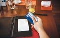 Woman hand  with credit card which she is a  receipt bill  food and drink for payment by credit card in the Royalty Free Stock Photo