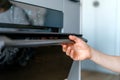 Selective focus on woman hand opening glass door of electric oven in modern kitchen Royalty Free Stock Photo