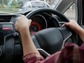 Woman hand on steering wheel driving a car with both hands Royalty Free Stock Photo