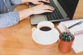 Selective focus woman` hand wore  Blue striped shirt  Typing on keybord,work online lifestyle relax at home with coffee ,home work Royalty Free Stock Photo