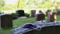 Female praying near tombstone with mask