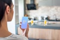 selective focus of woman holding smartphone with shazam logo on screen Royalty Free Stock Photo