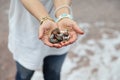 selective focus of  woman's hand full of colorful beach rocks Royalty Free Stock Photo