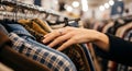 Woman\'s Hand Browsing Clothes on a Rack Royalty Free Stock Photo