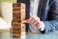 Selective focus at wood brick. Business people dress in formal suit taking risk and make decision to play the game. Insurance or