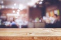 Selective focus.Wood table top with blur light bokeh in dark night cafe,restaurant background Royalty Free Stock Photo