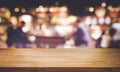 Selective focus.Wood table top with blur light bokeh in dark night cafe,restaurant background Royalty Free Stock Photo