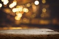 Selective focus.Wood table top with blur light bokeh in dark night cafe,restaurant background Royalty Free Stock Photo