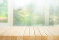 Selective focus.Wood table top on blur of window with garden flower background in morning Royalty Free Stock Photo