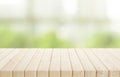 Selective focus.Wood table top on blur of window with garden flower background in morning Royalty Free Stock Photo