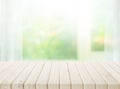 Selective focus.Wood table top on blur of window with garden flower background in morning Royalty Free Stock Photo
