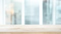 Selective focus of wood table top on white wall glass background