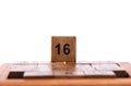 Selective focus. Wooden cube number 16 not used in the puzzle Game 15 Royalty Free Stock Photo