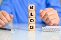 Selective focus the word Blog on background of a businessman - business benefits from blogging